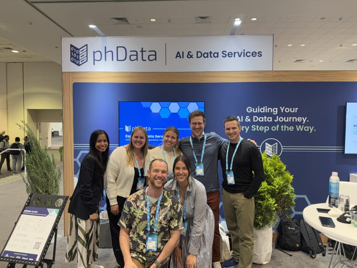 A picture of 5 people at the phData booth at Snowflake Summit